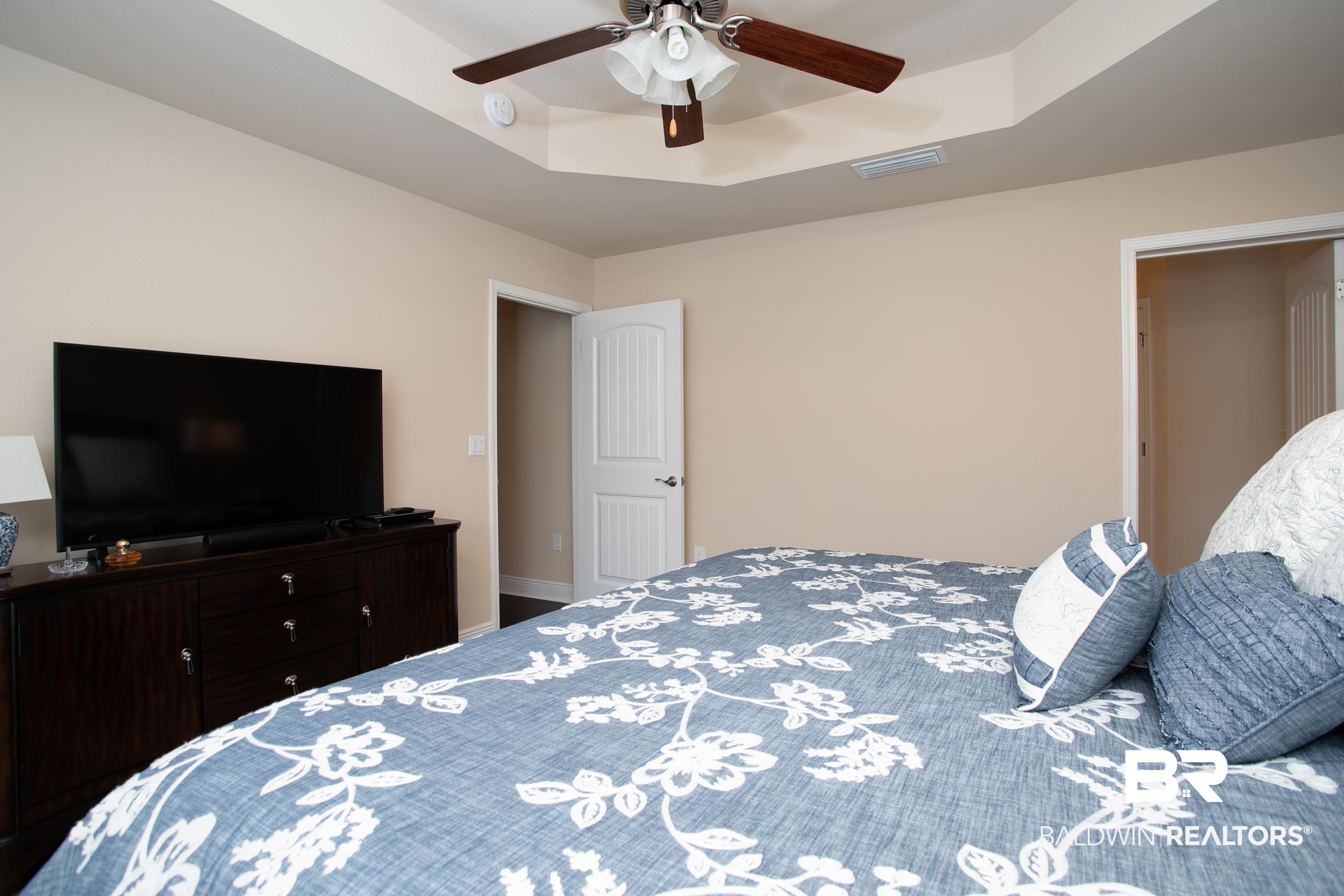 13154 Vincent Court Foley, AL 36535 - Photo 14 of 41 Bedroom featuring baseboards, visible vents, a ceiling fan, and a raised ceiling
