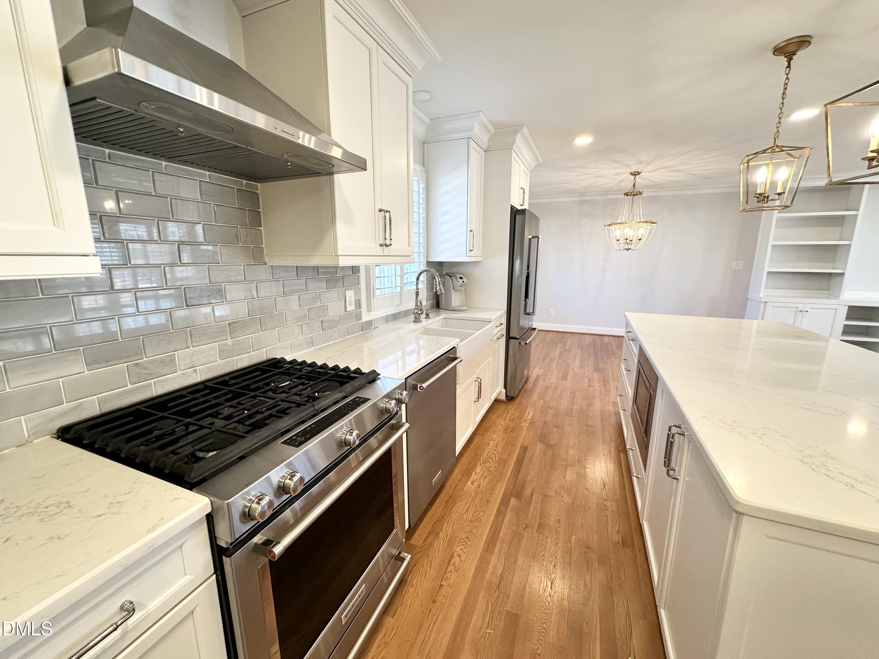 4512 Drexel Drive Raleigh, NC 27609 - Photo 11 of 36 a kitchen with granite countertop a stove and a wooden floors