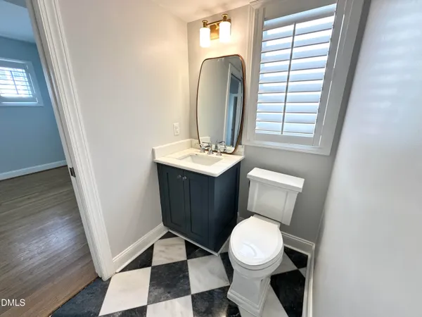 a bathroom with a toilet a sink and a mirror