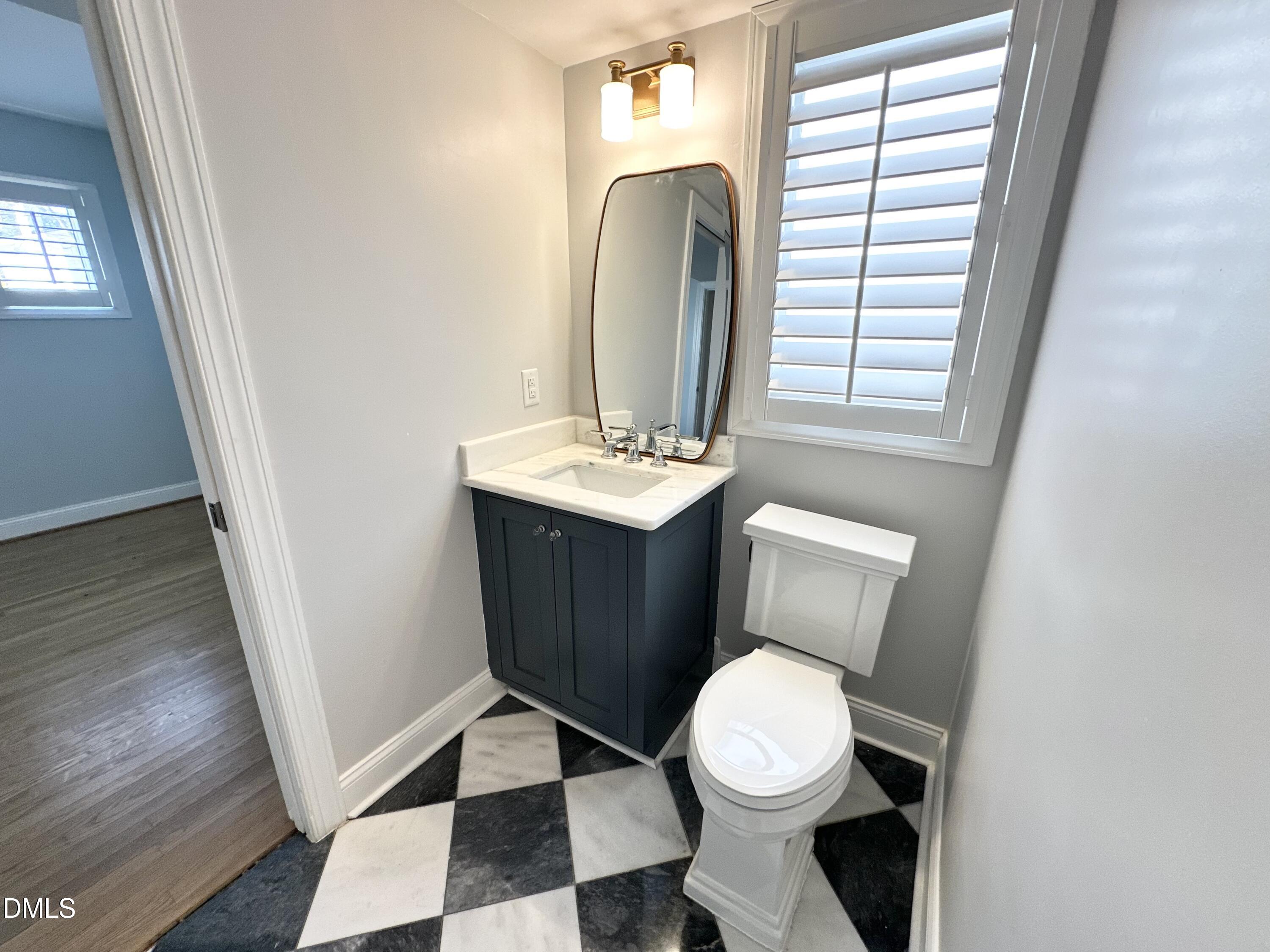 4512 Drexel Drive Raleigh, NC 27609 - Photo 16 of 36 a bathroom with a toilet a sink and a mirror
