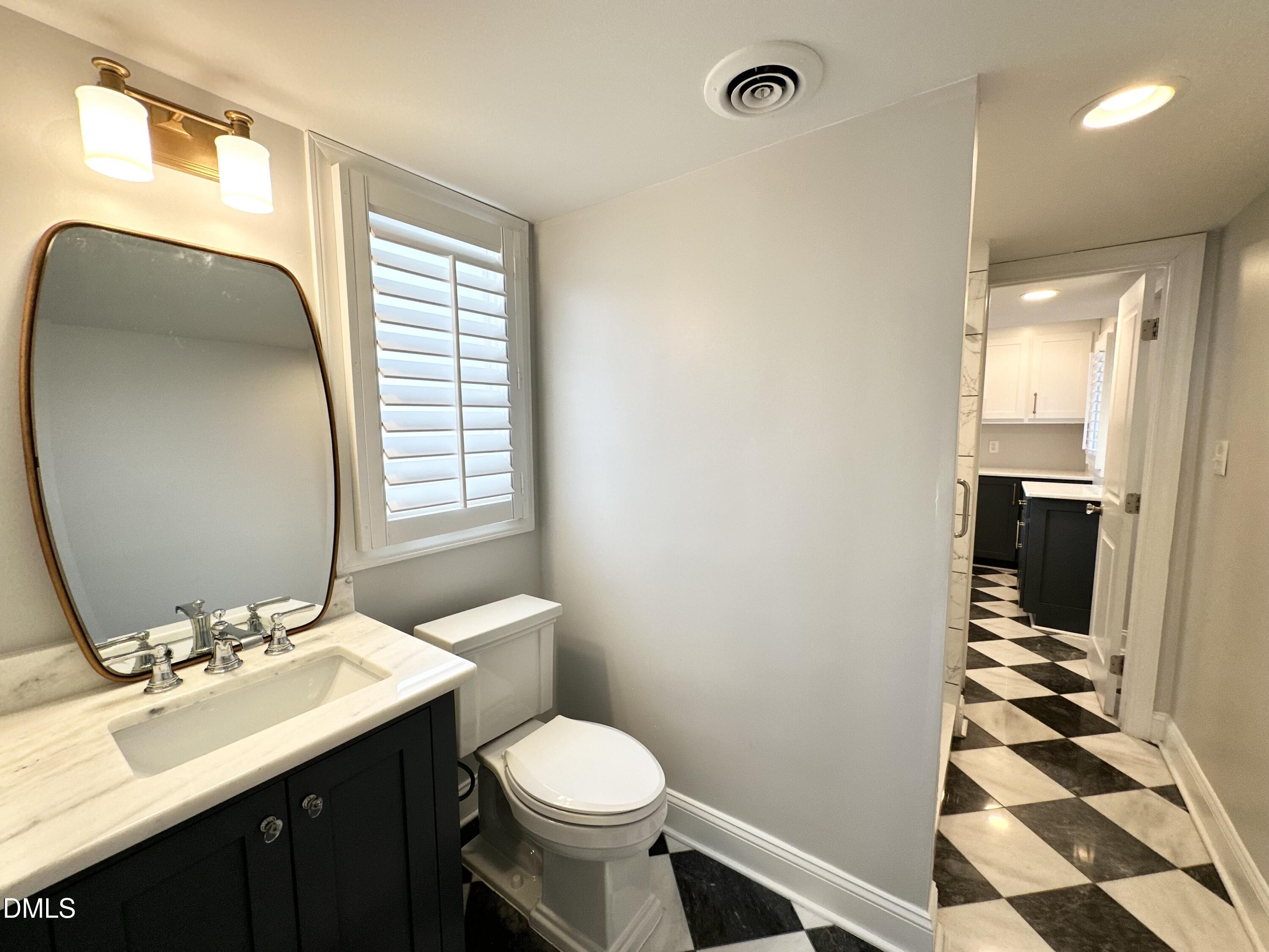 4512 Drexel Drive Raleigh, NC 27609 - Photo 17 of 36 a bathroom with a sink toilet and shower