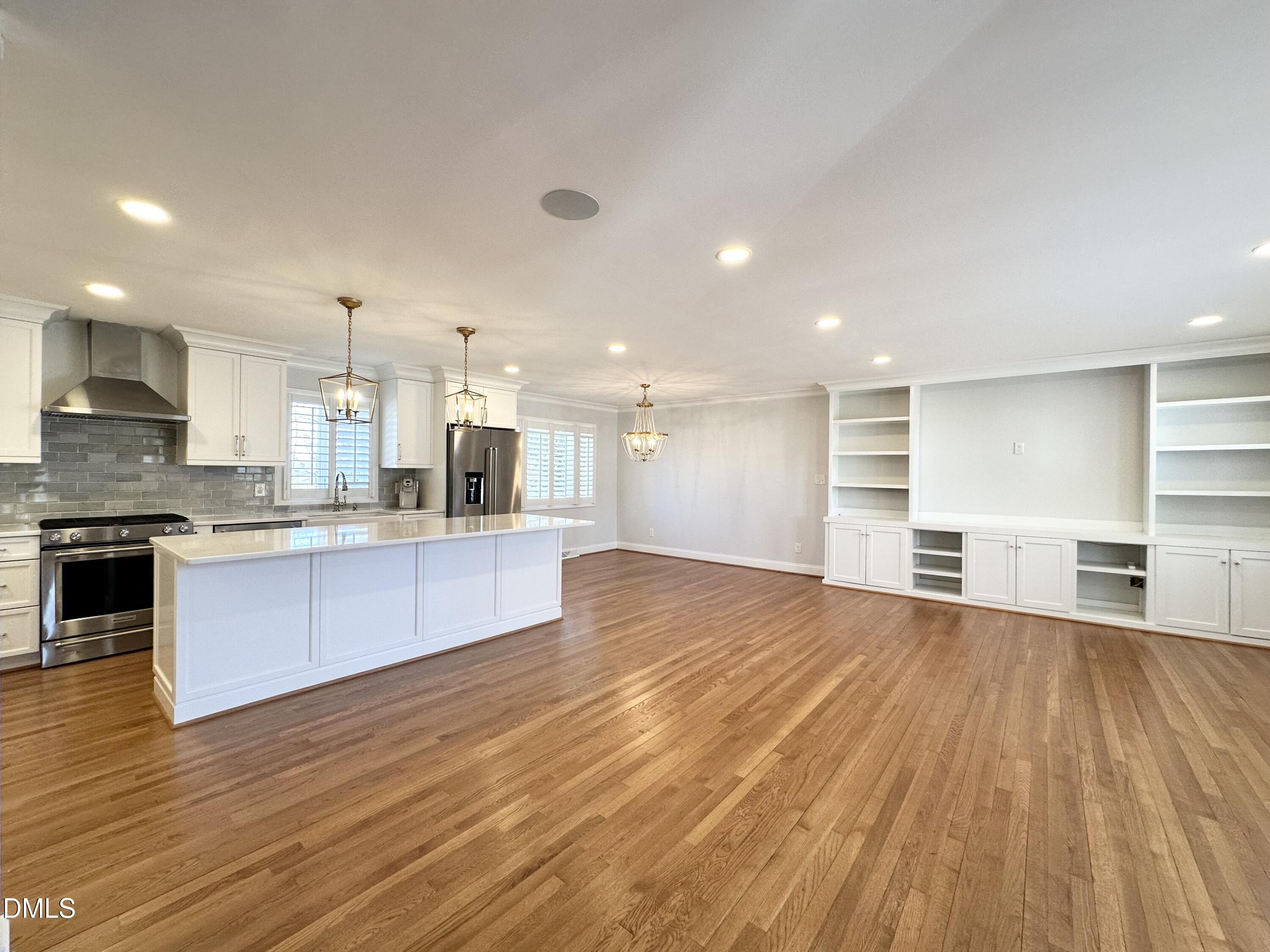 4512 Drexel Drive Raleigh, NC 27609 - Photo 2 of 36 a large kitchen with stainless steel appliances granite countertop a large counter top and a stove top oven with wooden floor