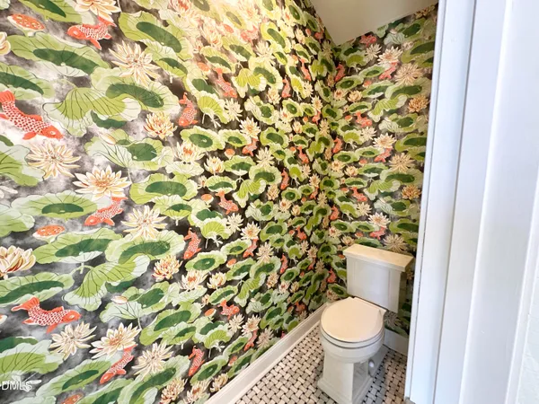 a white toilet sitting next to a shower curtain