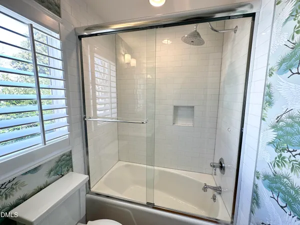 a bathroom with a shower and a bathtub