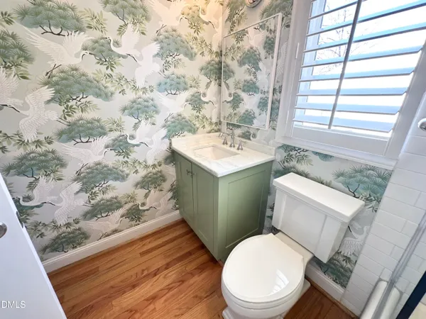 a white toilet sitting next to a shower curtain