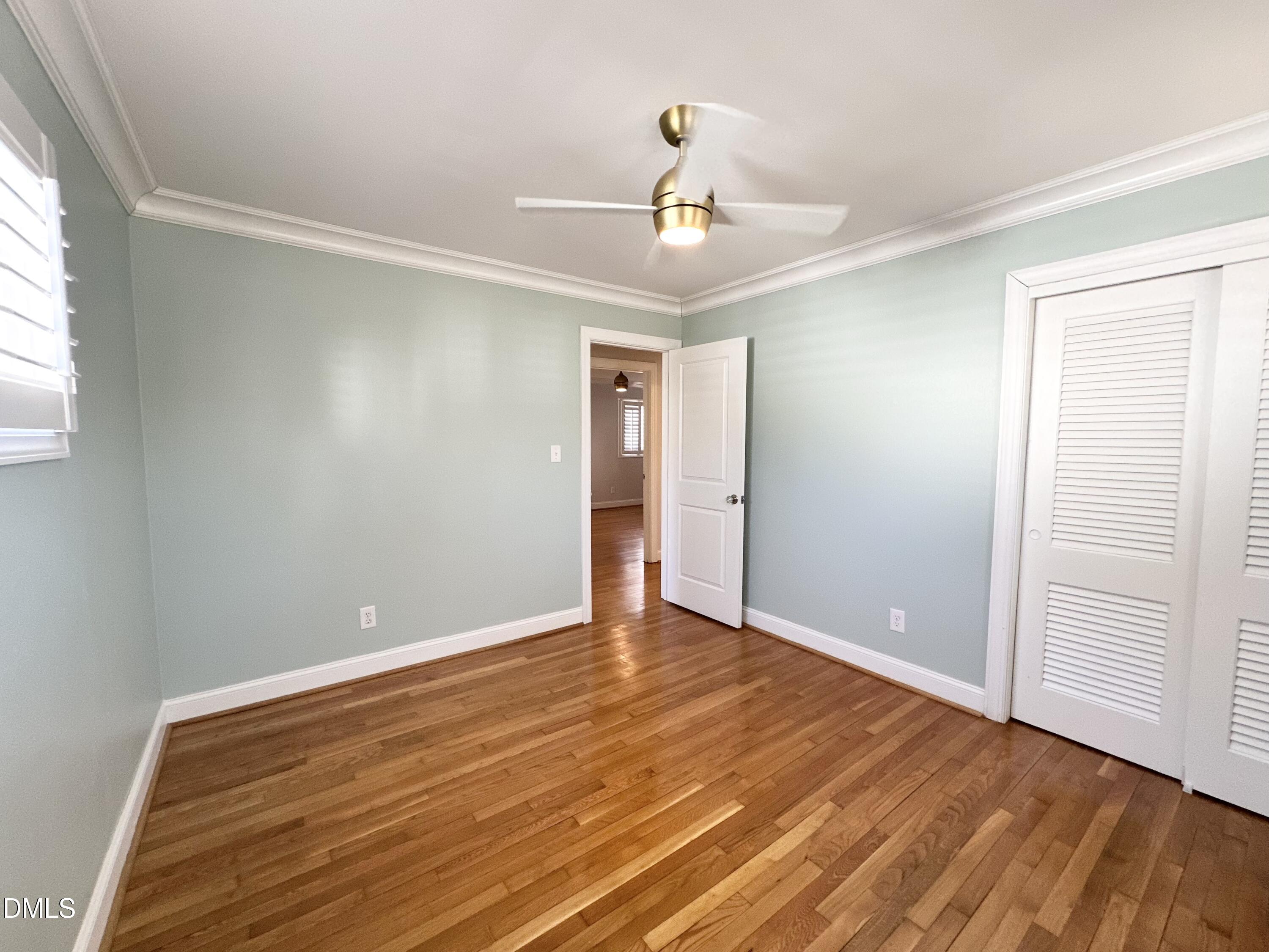 4512 Drexel Drive Raleigh, NC 27609 - Photo 30 of 36 a view of an empty room with wooden floor and a window