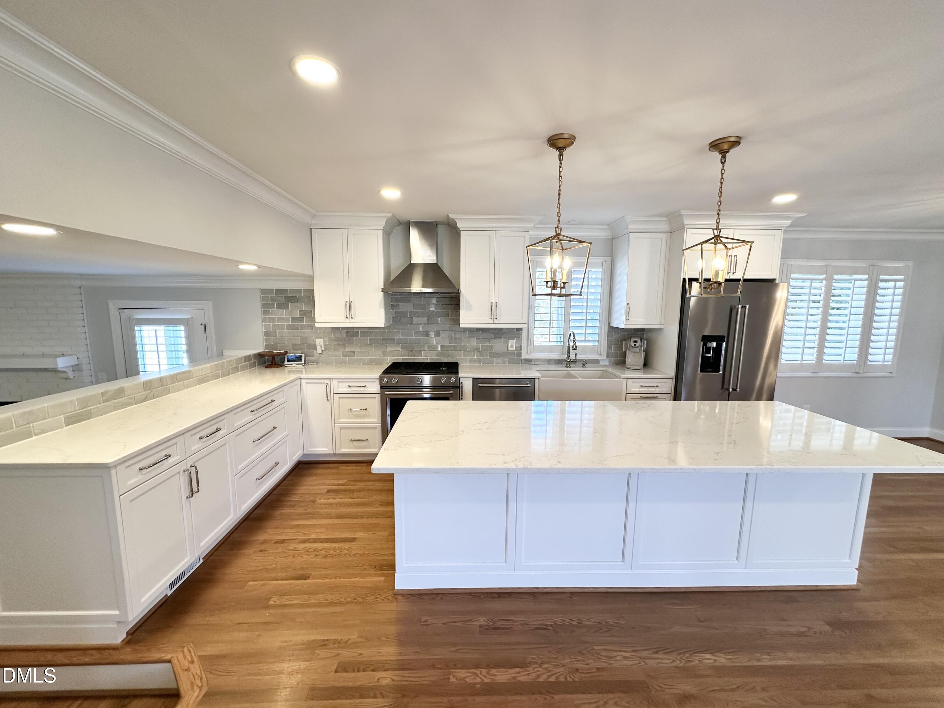 4512 Drexel Drive Raleigh, NC 27609 - Photo 3 of 36 a large kitchen with kitchen island a stove a sink a refrigerator and a center island