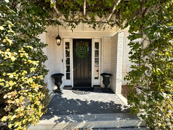 a front view of a house with a tree