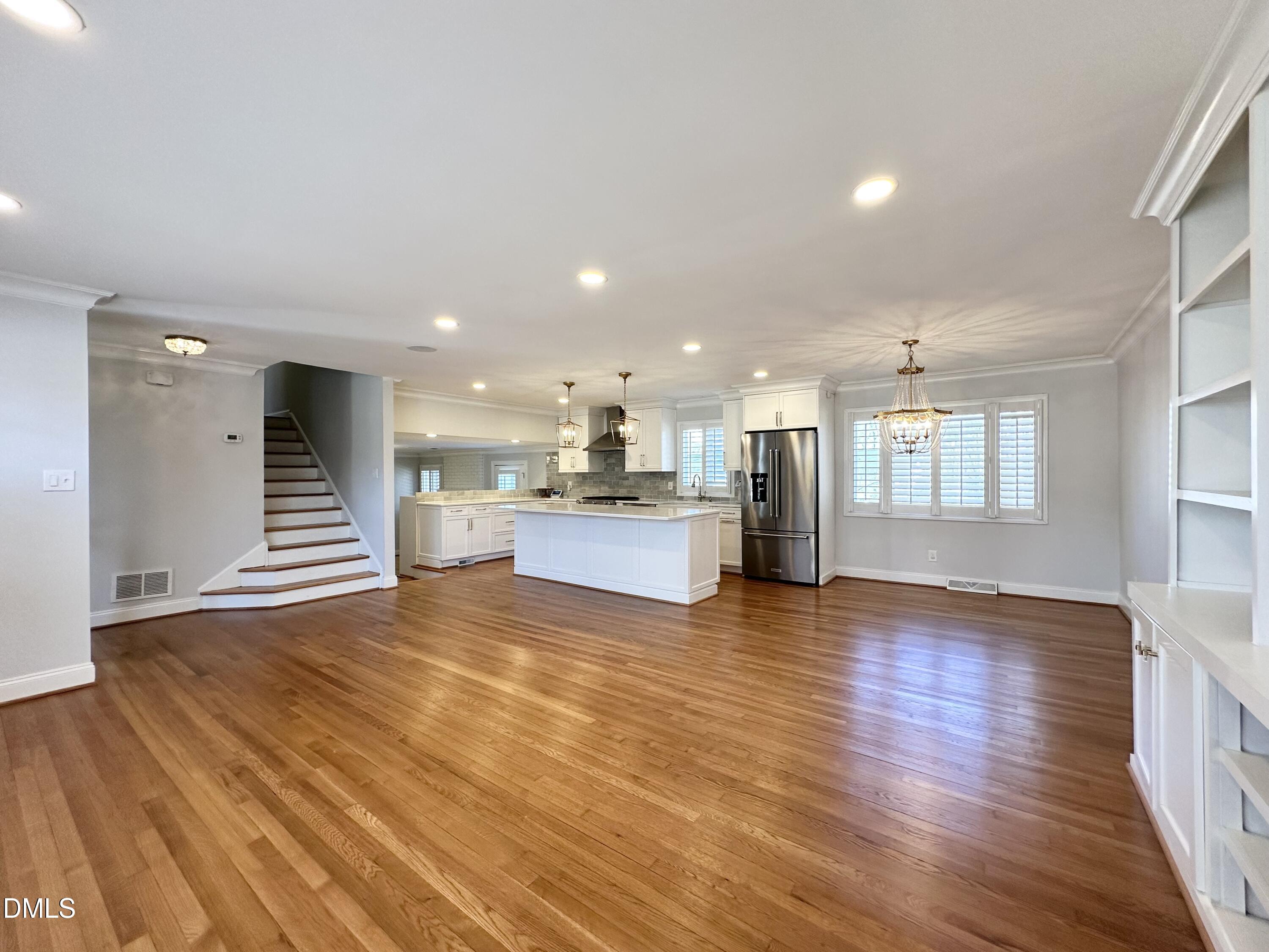 4512 Drexel Drive Raleigh, NC 27609 - Photo 8 of 36 a view of an empty room with wooden floor and kitchen