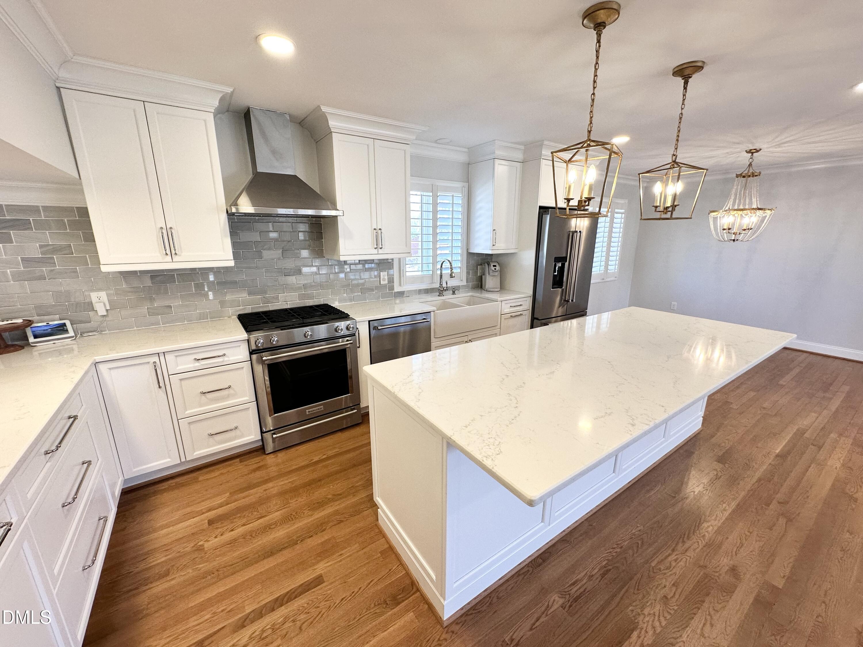 4512 Drexel Drive Raleigh, NC 27609 - Photo 10 of 36 a kitchen with stainless steel appliances kitchen island granite countertop a sink a stove and a wooden floors