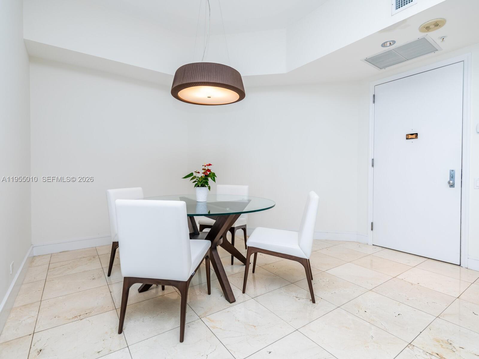 888 Brickell Key Drive, Unit 210 Miami, FL 33131 - Photo 13 of 84 a view of a dining room with furniture