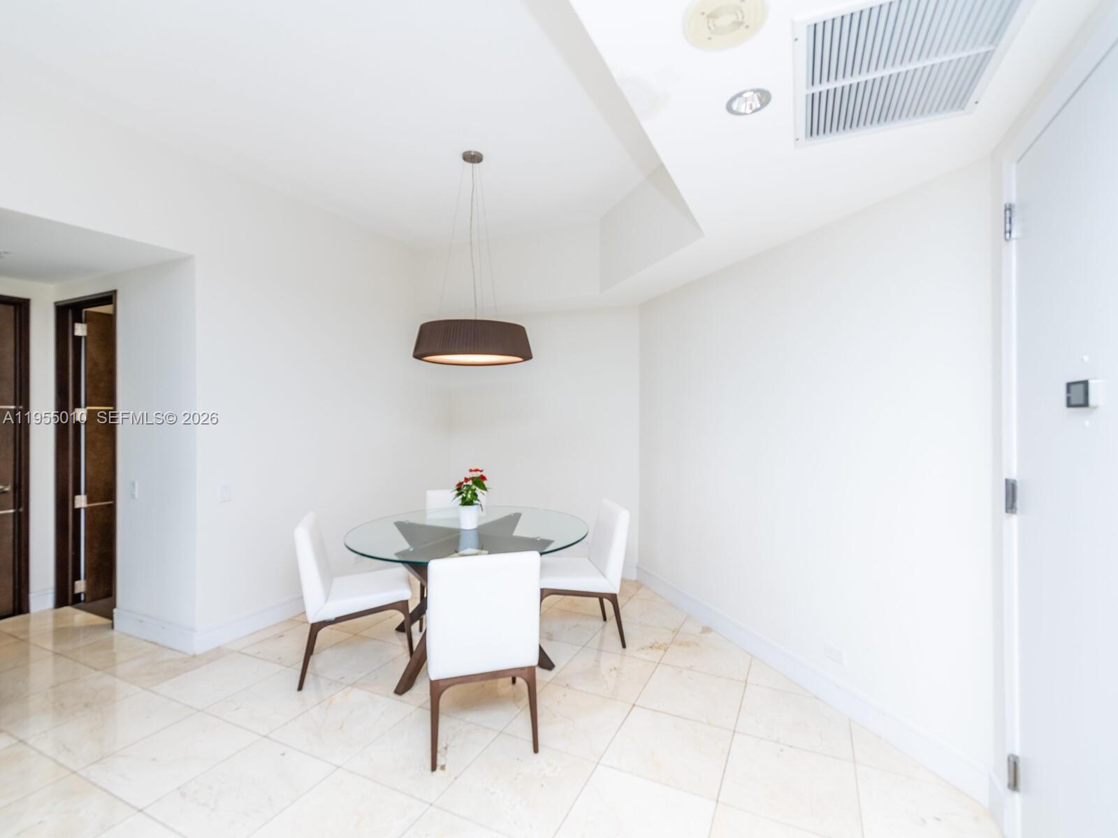 888 Brickell Key Drive, Unit 210 Miami, FL 33131 - Photo 14 of 84 a view of a room with table and chair