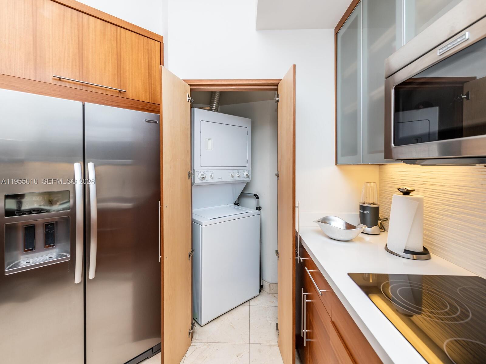 888 Brickell Key Drive, Unit 210 Miami, FL 33131 - Photo 24 of 84 a kitchen with a refrigerator sink and cabinets