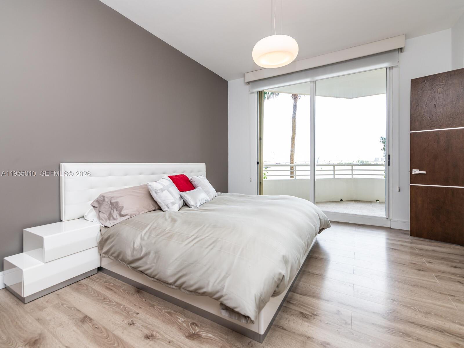 888 Brickell Key Drive, Unit 210 Miami, FL 33131 - Photo 27 of 84 a bedroom with a bed and a large window