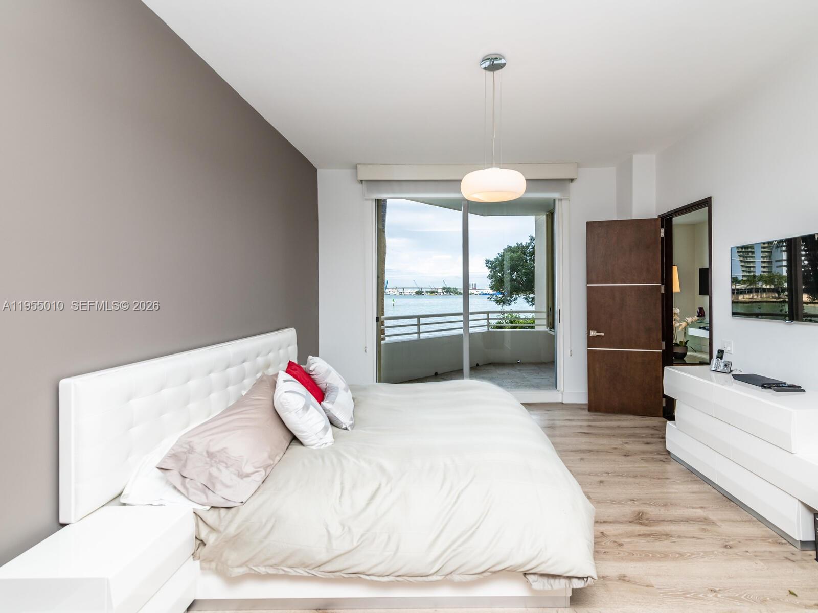 888 Brickell Key Drive, Unit 210 Miami, FL 33131 - Photo 29 of 84 a bedroom with a bed and a large window