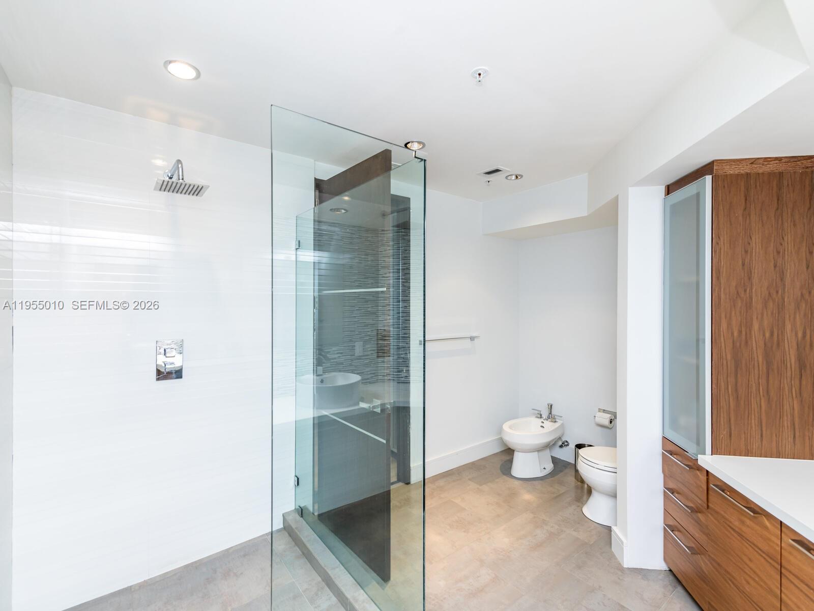 888 Brickell Key Drive, Unit 210 Miami, FL 33131 - Photo 32 of 84 a bathroom with a toilet and a shower