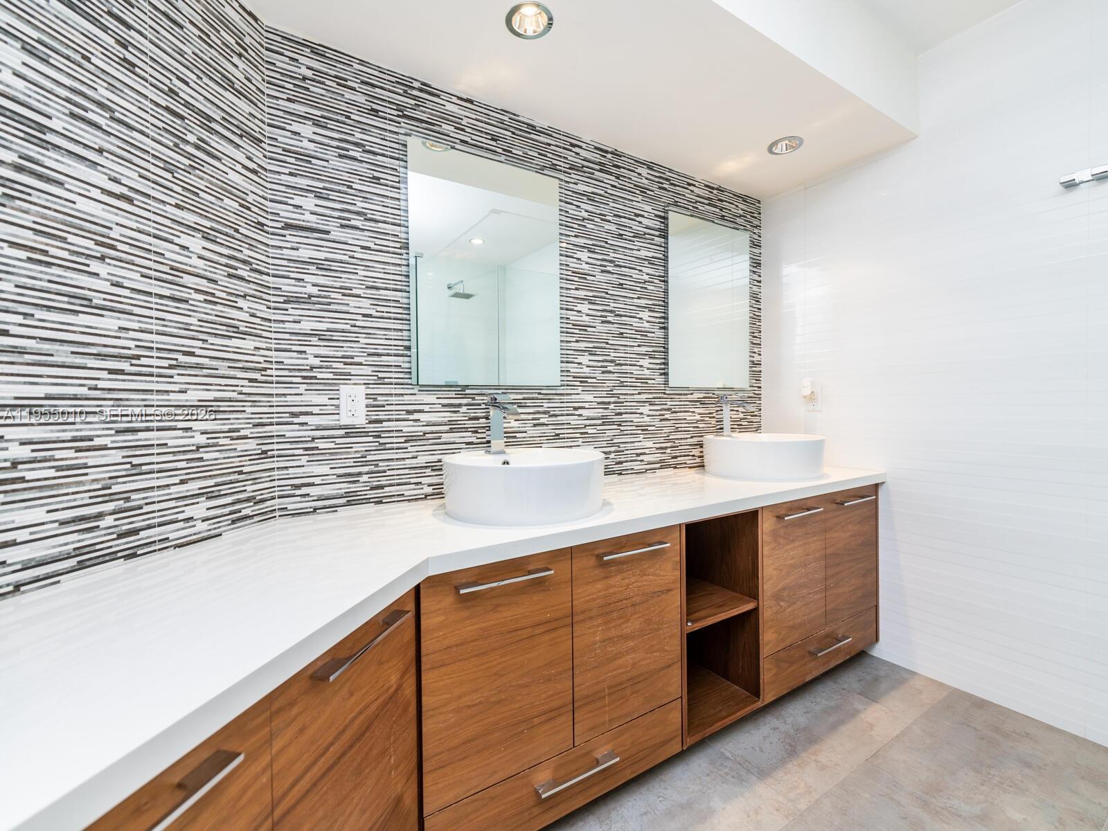 888 Brickell Key Drive, Unit 210 Miami, FL 33131 - Photo 35 of 84 a bathroom with a sink and a mirror