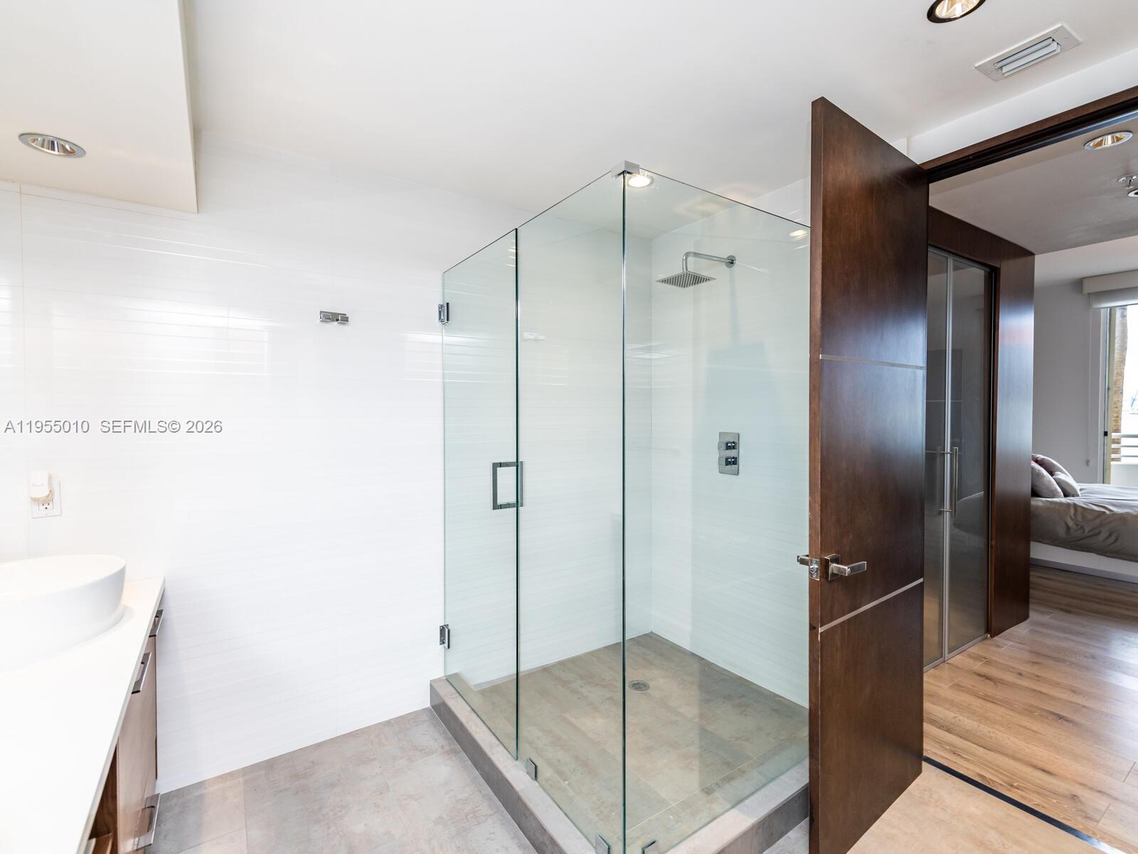 888 Brickell Key Drive, Unit 210 Miami, FL 33131 - Photo 37 of 84 a bathroom with a glass shower door
