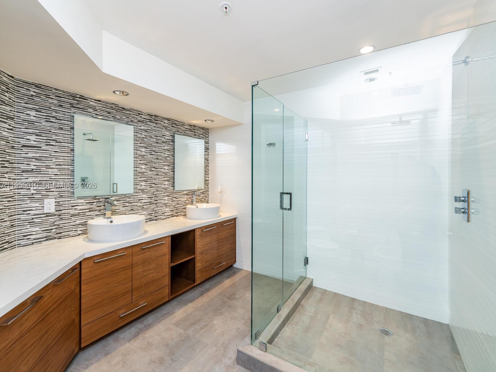 888 Brickell Key Drive, Unit 210 Miami, FL 33131 - Photo 38 of 84 a bathroom with a double vanity sink mirror and double