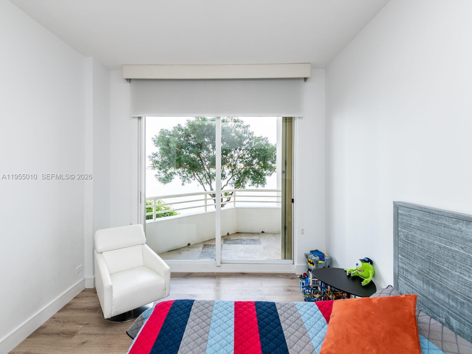 888 Brickell Key Drive, Unit 210 Miami, FL 33131 - Photo 40 of 84 a living room with furniture and a large window