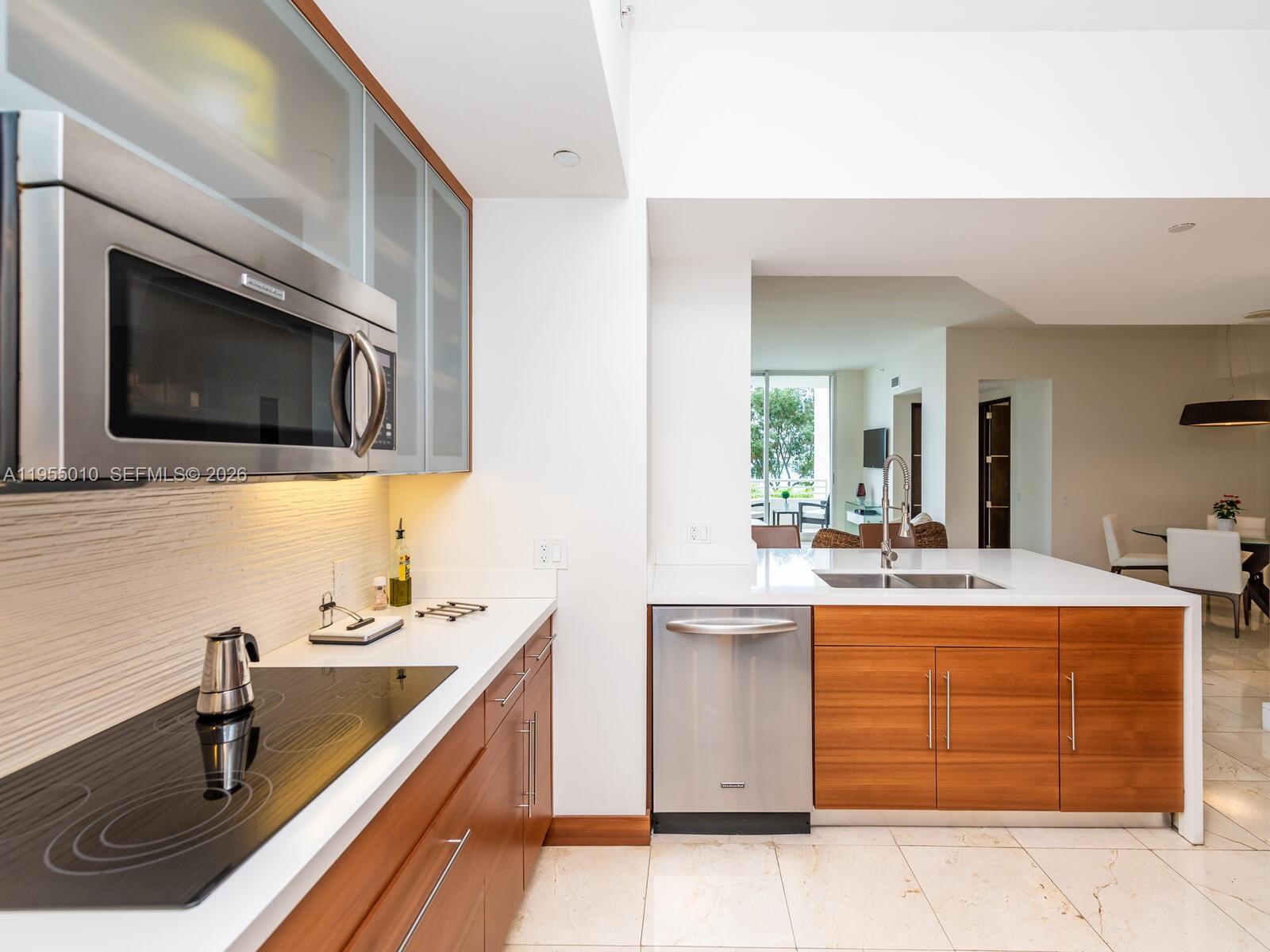 888 Brickell Key Drive, Unit 210 Miami, FL 33131 - Photo 8 of 84 a kitchen with a sink stove and microwave