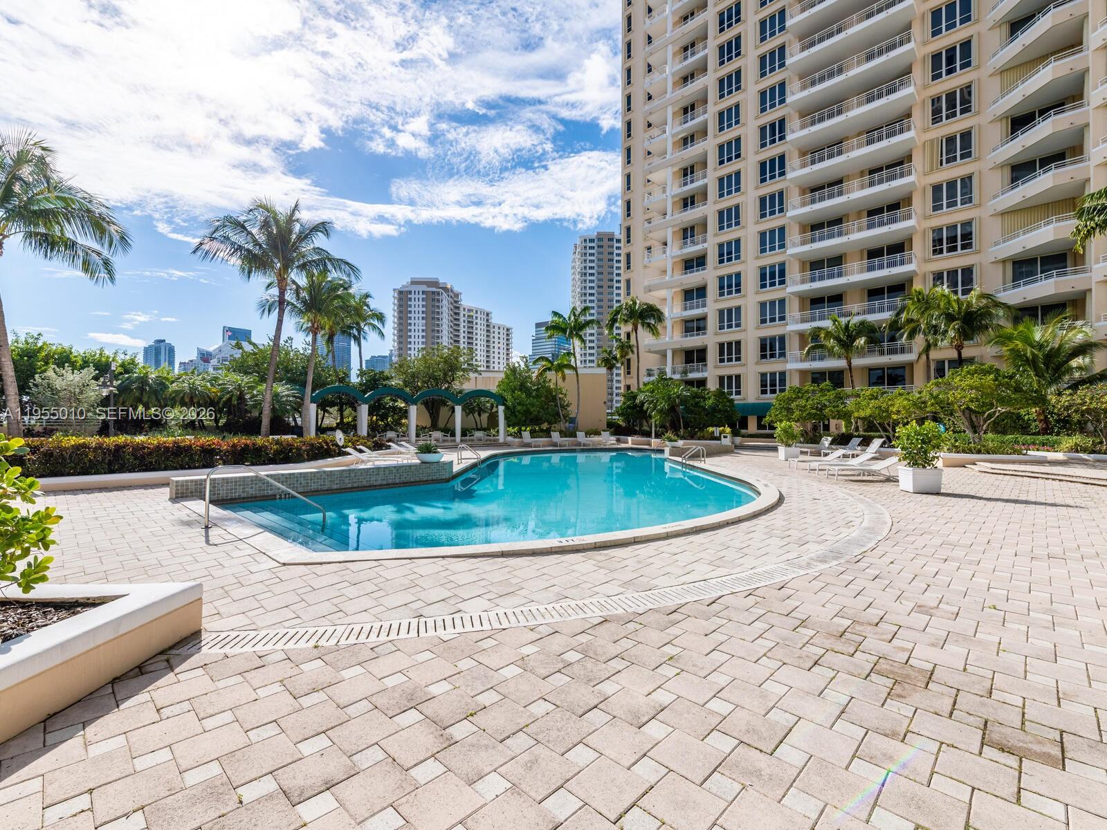 888 Brickell Key Drive, Unit 210 Miami, FL 33131 - Photo 82 of 84 a view of a swimming pool and a yard