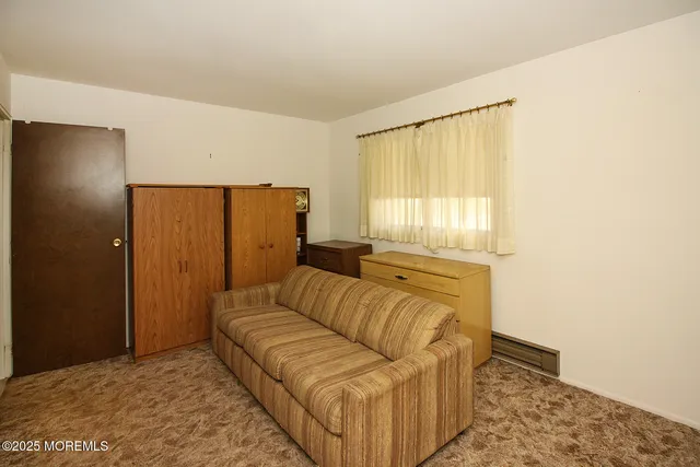 a living room with a couch and a dresser