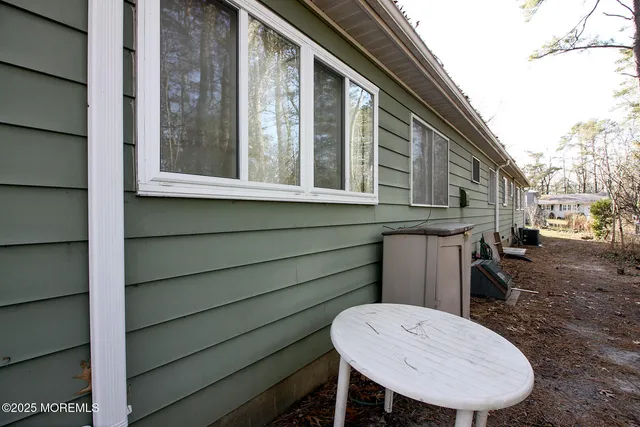 a view of a chair and table in the backyard