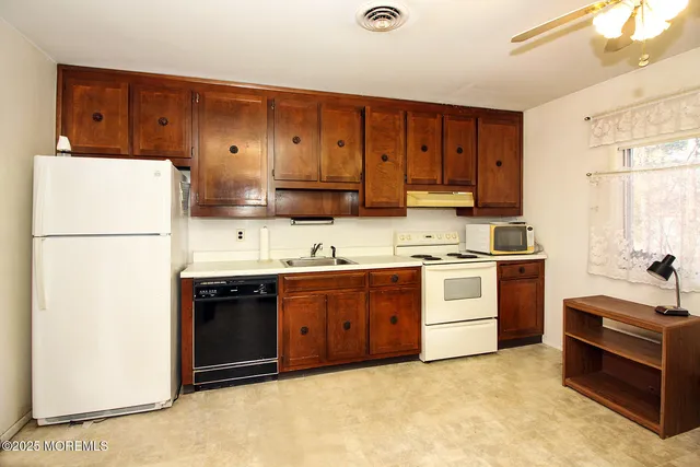 a kitchen with a sink stove and refrigerator