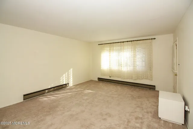 an empty room with a empty space and windows