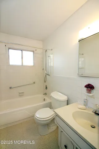a bathroom with a toilet a sink and a bathtub