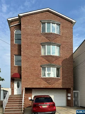 a front view of a house with parking