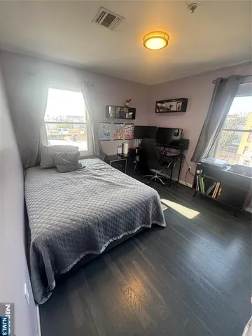a bedroom with a bed and window