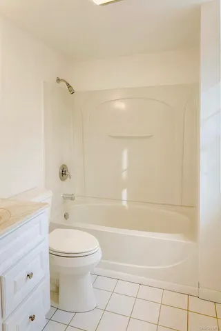 a bathroom with a toilet a sink and shower