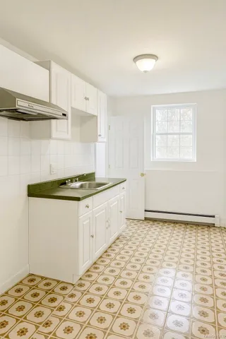 a kitchen with a cabinets and a stove top oven
