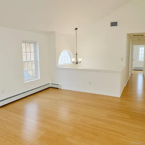 a view of a room with wooden floor and window