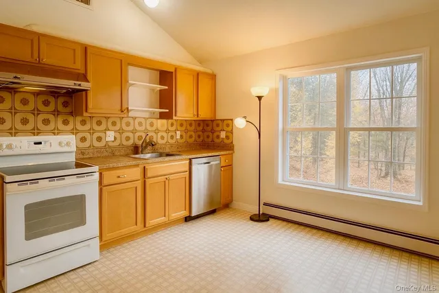 a kitchen with a stove a sink and a microwave