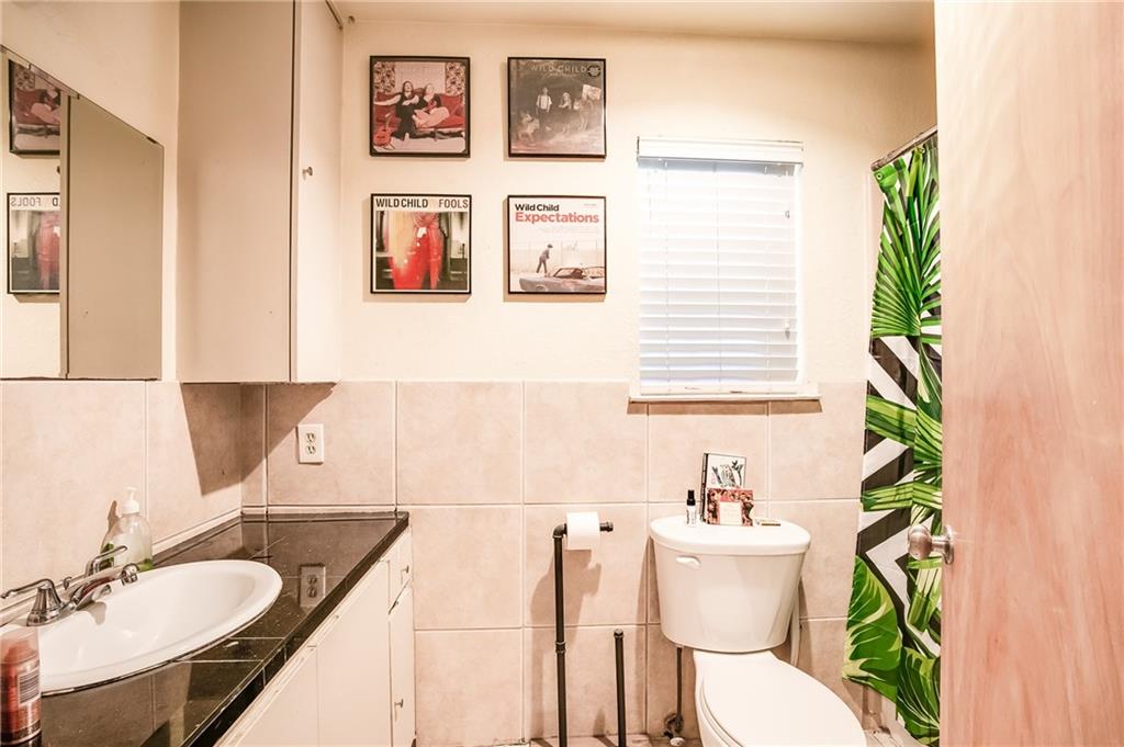2400 Thornton Road, Unit A Austin, TX 78704 - Photo 13 of 15 a bathroom with a granite countertop sink and a mirror