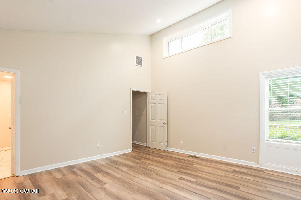 7 Timberlake Drive Jackson, TN 38305 - Photo 15 of 38 a view of an empty room with wooden floor and a window