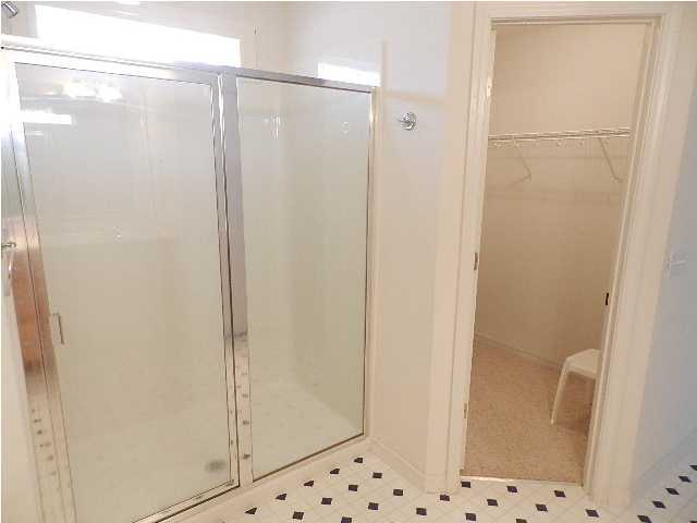 2388 Cove Road Navarre, FL 32566 - Photo 17 of 32 a bathroom with a glass shower door