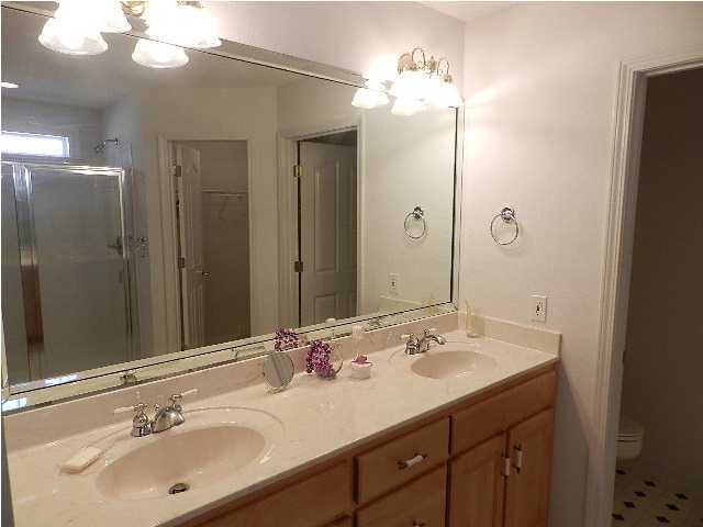 2388 Cove Road Navarre, FL 32566 - Photo 18 of 32 a bathroom with a sink double vanity and a mirror