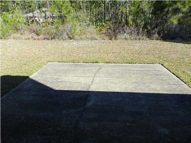 2388 Cove Road Navarre, FL 32566 - Photo 28 of 32 a view of a dry yard with wooden floor