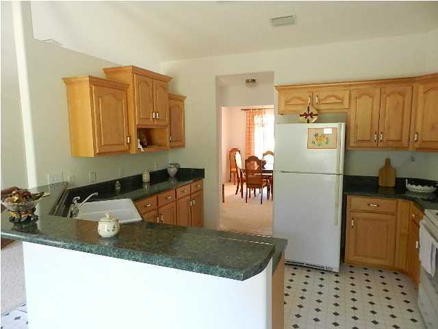 2388 Cove Road Navarre, FL 32566 - Photo 10 of 32 a kitchen with stainless steel appliances granite countertop a sink a refrigerator and a stove