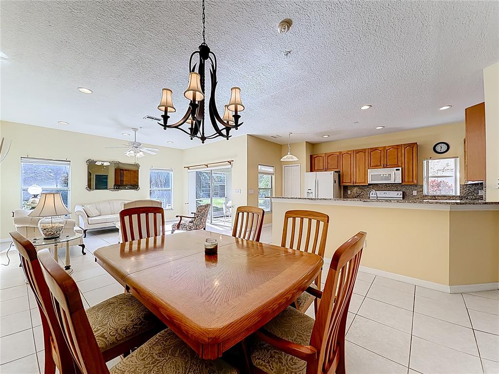 11117 Kapok Grand Circle Madeira Beach, FL 33708 - Photo 11 of 62 a view of a dining room with furniture