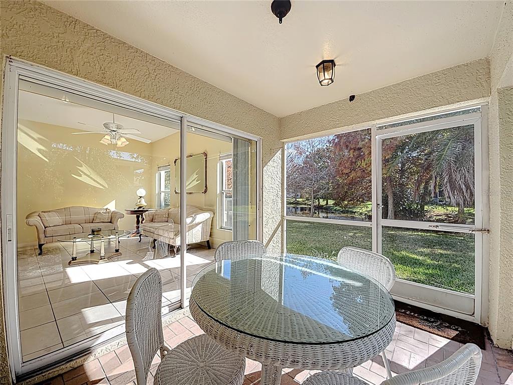 11117 Kapok Grand Circle Madeira Beach, FL 33708 - Photo 18 of 62 a dining room with wooden floor and a table