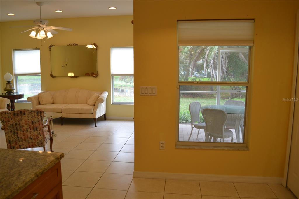 11117 Kapok Grand Circle Madeira Beach, FL 33708 - Photo 21 of 62 a living room with couches and painting on the wall