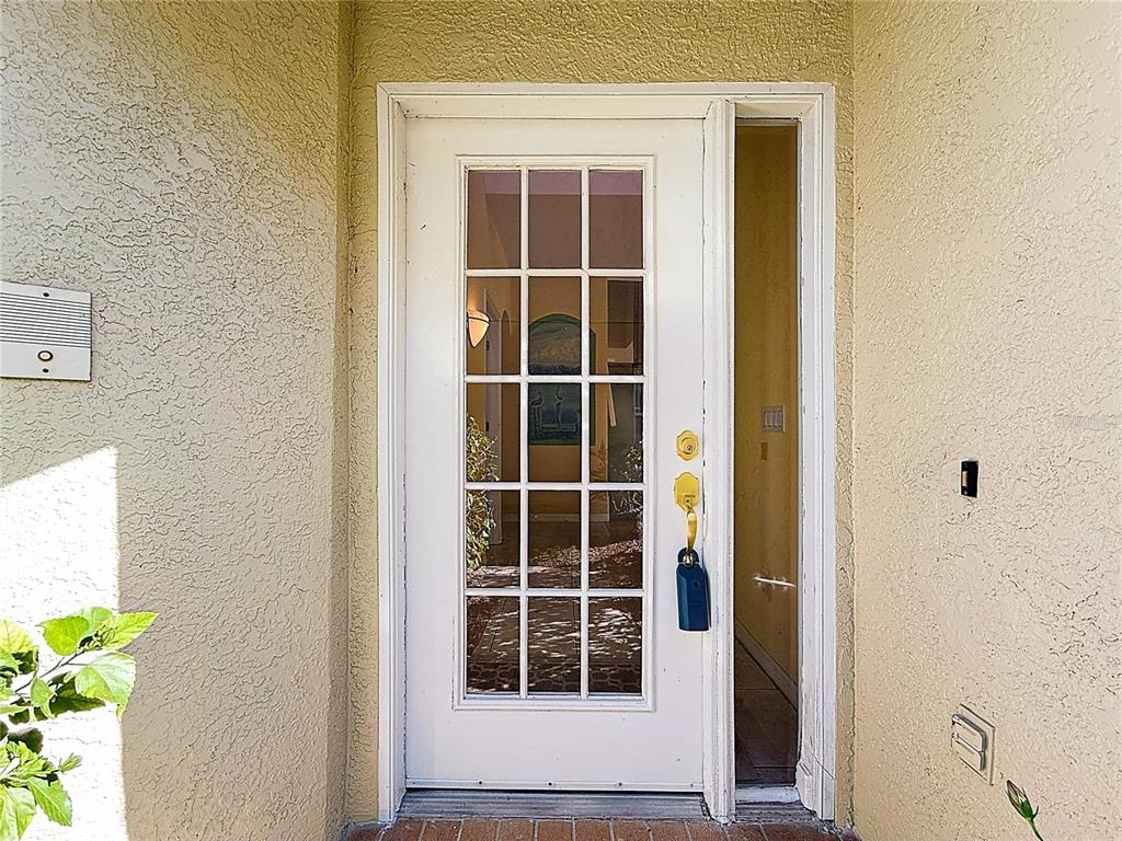 11117 Kapok Grand Circle Madeira Beach, FL 33708 - Photo 3 of 62 a front view of a house with a window
