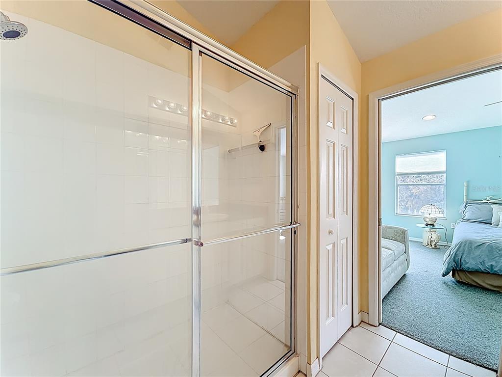 11117 Kapok Grand Circle Madeira Beach, FL 33708 - Photo 33 of 62 a bathroom with a shower and a sink