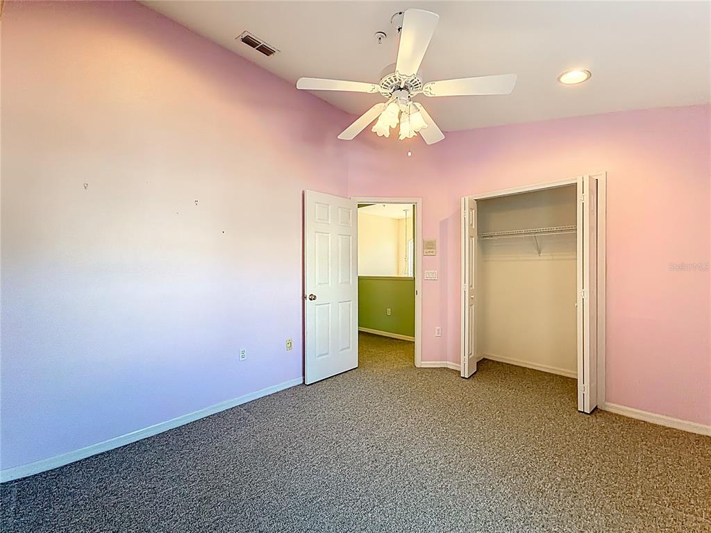 11117 Kapok Grand Circle Madeira Beach, FL 33708 - Photo 37 of 62 an empty room with closet and a chandelier fan