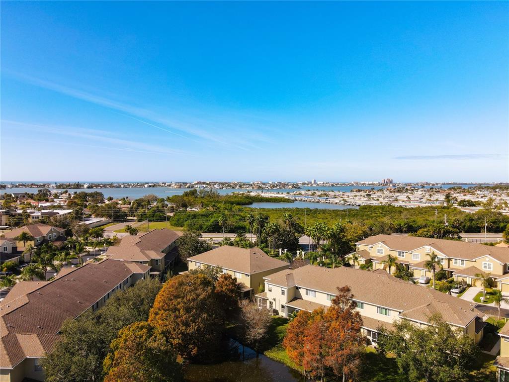 11117 Kapok Grand Circle Madeira Beach, FL 33708 - Photo 42 of 62 an aerial view of ocean and residential houses with outdoor space